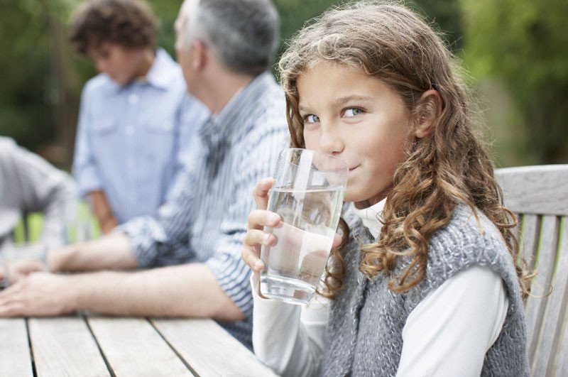 Girl drinking water outside