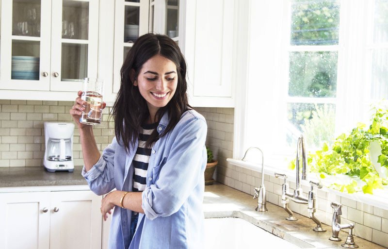 Woman smiling and drinking water